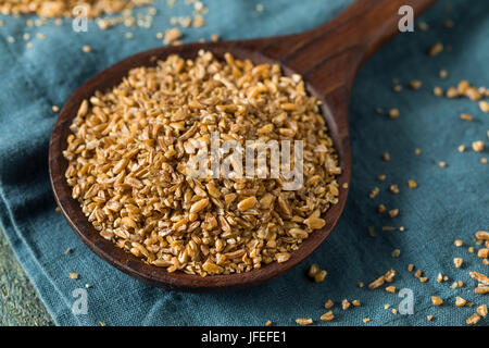 Raw Organic Brown Bulgar Wheat in a Spoon Stock Photo