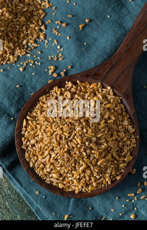 Raw Organic Brown Bulgar Wheat in a Spoon Stock Photo