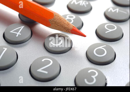 Red pen on electronic calculator as an icon for savings Stock Photo