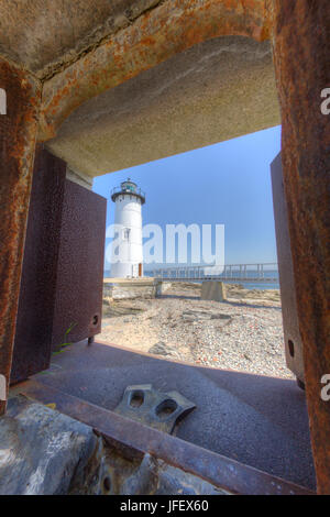 View of Portsmouth Harbor Lighthouse through the ruins of a gun turret at old Fort Constitution. Stock Photo