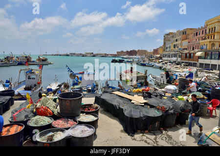 Trawler fishing boats moored with nets on quayside Anzio, Italy Stock Photo