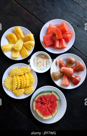 Plates with tropical fruits Stock Photo