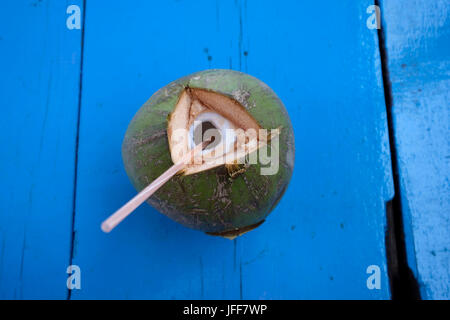 Coconut water with straw Stock Photo