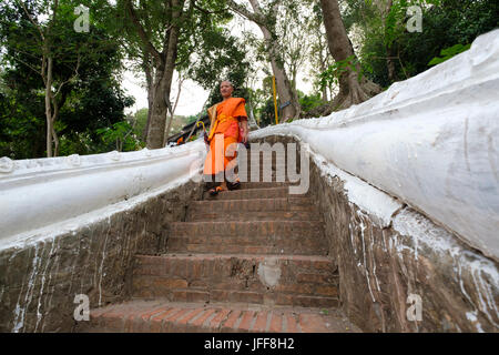 Buddhist monk walking down the Thanon Phousi staircase on the Mount Phou Si, Luang Prabang, Laos, Asia Stock Photo