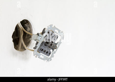 Installation of electrical contacts on the white wall. Stock Photo