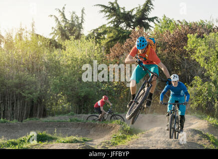 Mountain Biker biking through dirt course Stock Photo