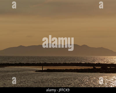 Isle of arran at twilight from Ayr beach sunset thought by many to be the island of Avalon of Arthurian legend Stock Photo