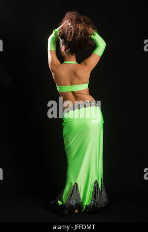 brunette in a green suit oriental dance Stock Photo