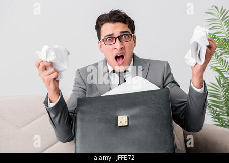 Angry businessman with crumbled paper Stock Photo