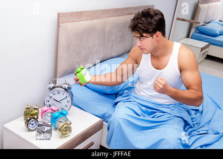 Man having trouble waking up in morning Stock Photo