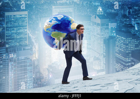 Businessman carrying Earth on his shoulders Stock Photo