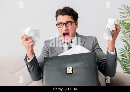 Angry businessman with crumbled paper Stock Photo