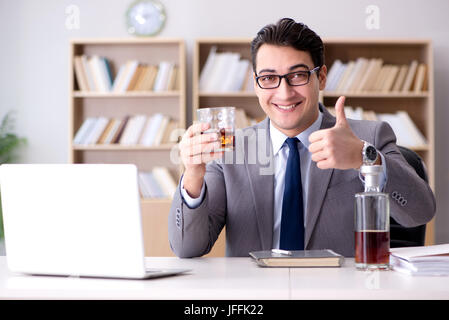 Young businessman drinking from stress Stock Photo