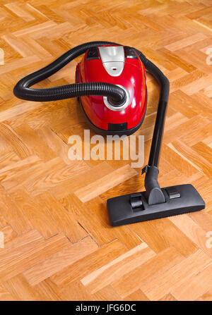 Vacuum cleaner on parquet Stock Photo