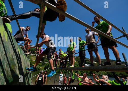 Athletes participating on an obstacle course race Stock Photo