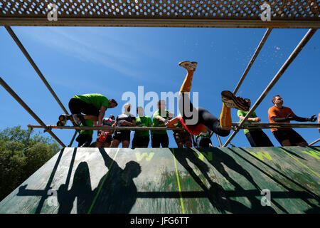 Athletes participating on an obstacle course race Stock Photo