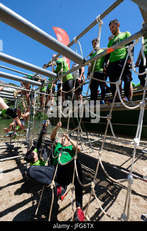 Athletes participating on an obstacle course race Stock Photo