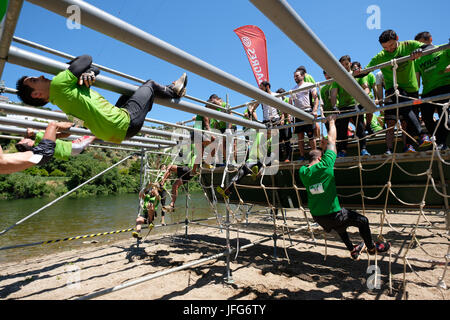 Athletes participating on an obstacle course race Stock Photo