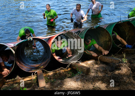Athletes participating on an obstacle course race Stock Photo
