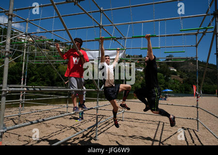 Athletes participating on an obstacle course race Stock Photo