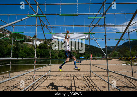 Athlete participating on an obstacle course race Stock Photo