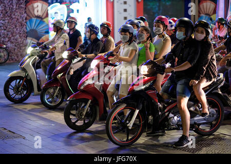 Hundreds of Vietnamese people riding motorcycles on the streets of Ho Chi Minh City in Vietnam, Asia Stock Photo