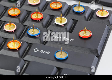 Pins on computer keyboard Stock Photo