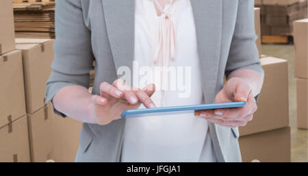 Composite image of close up of woman using tablet Stock Photo