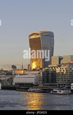 The Modern skyline of the City of London with The Walkie Talkie Building with sunlight reflected in the River Thames, London, England Stock Photo