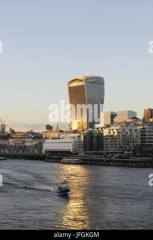 The Modern skyline of the City of London with The Walkie Talkie Building with sunlight reflected in the River Thames, London, England Stock Photo