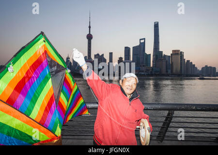 China, Shanghai, The Bund, Elderly Kite Flyer at Dawn Stock Photo
