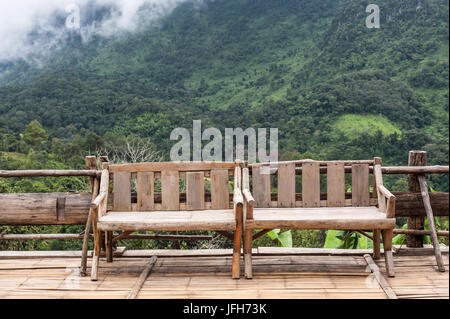 chairs in a wooden terrace natural hill background Stock Photo