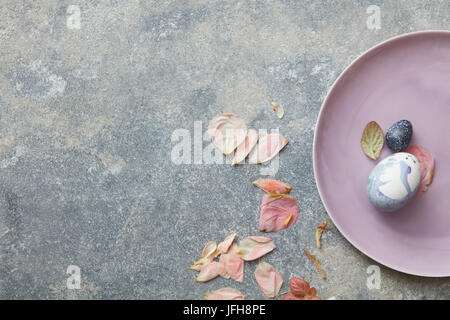 Blue easter eggs on pink plate Stock Photo