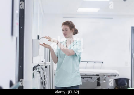 Hospital nurse disinfecting hands Stock Photo