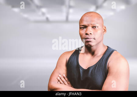 Composite image of portrait of bald bodybuilder with arms crossed Stock Photo