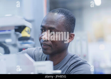 Close-up of worker repairing machine at engineering plant Stock Photo