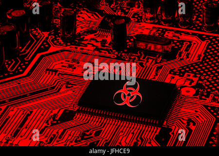 Red Computer Motherboard with biohazard logo ( virus ransomware attack concept) Stock Photo