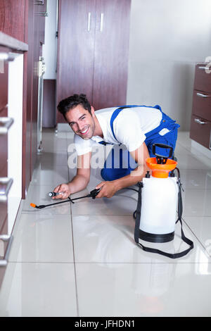 Cheerful man using torch while spraying insecticide Stock Photo