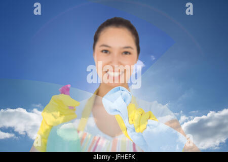 Composite image of happy woman wiping in front of her Stock Photo