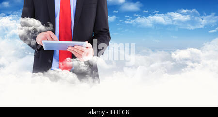 Composite image of businessman scrolling on his digital tablet Stock Photo