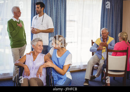 Nurses having discussions with seniors patients Stock Photo