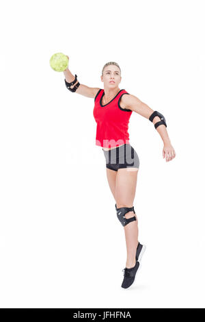 Female athlete with elbow pad throwing handball Stock Photo