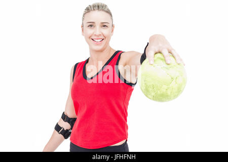Female athlete with elbow pad holding handball Stock Photo