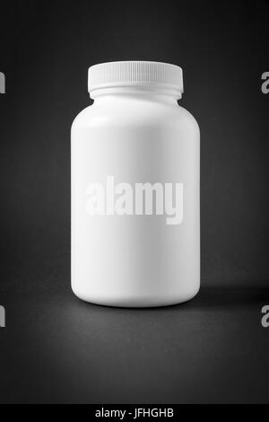 white plastic jar isolated on black Stock Photo