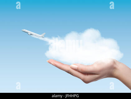 Woman holding cloud with plane taking off Stock Photo