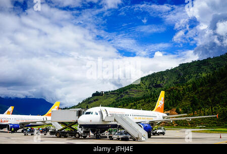 Thimphu, Bhutan - Aug 29, 2015. Airplanes docking at Paro Airport in Thimphu, Bhutan. Thimphu is the political and economic centre of Bhutan. Stock Photo