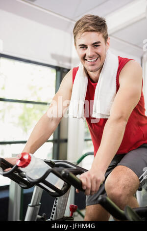 Man working out on exercise bike at spinning class Stock Photo