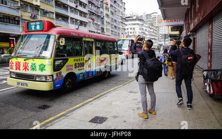 Hong Kong - Mar 29, 2017. People waiting for bus at Kowloon District in Hong Kong, China. Hong Kong ranks as the world fourth most densely populated s Stock Photo