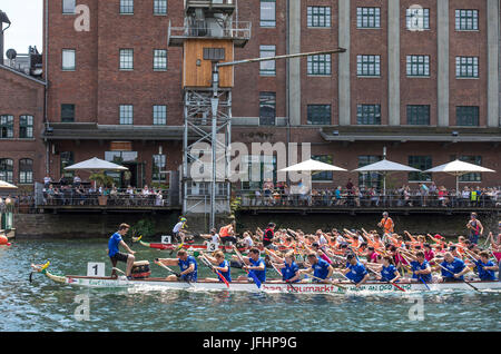 Dragonboat regatta in the inner harbor of Duisburg, Germany, racing in the scenery of old and new harbor buildings, the largest leisure time dragonboa Stock Photo