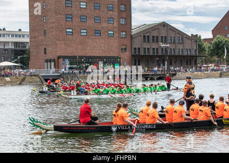 Dragonboat regatta in the inner harbor of Duisburg, Germany, racing in the scenery of old and new harbor buildings, the largest leisure time dragonboa Stock Photo